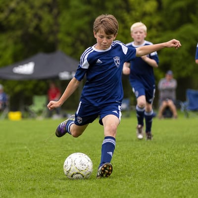 Child kicking a soccer ball
